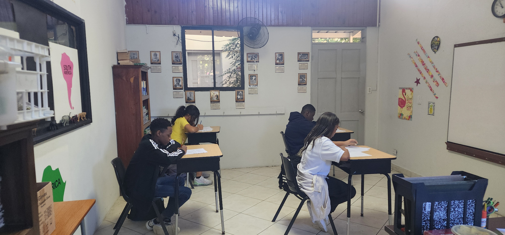 Middle school students working quietly at desks in an EXL classroom