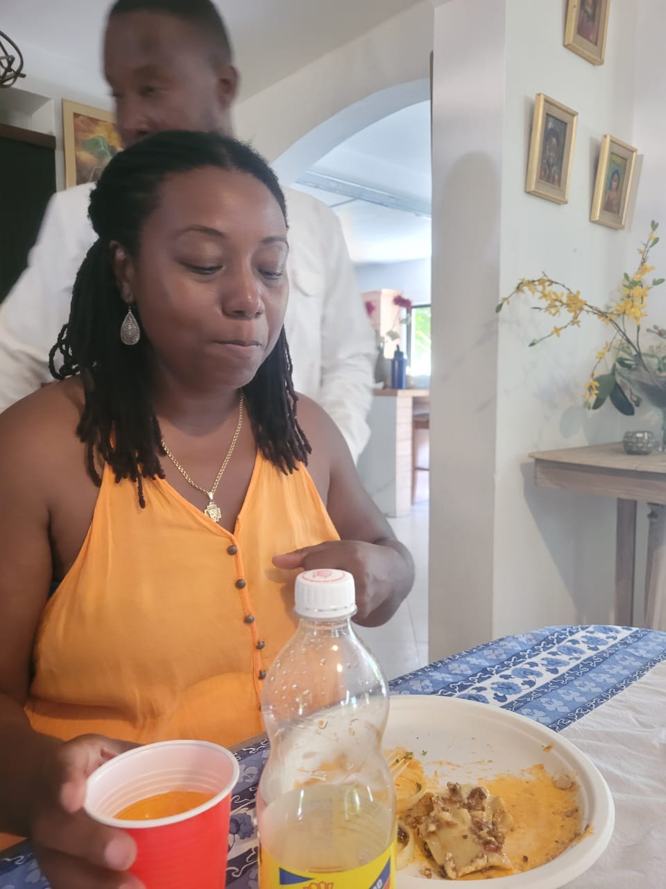 EXL staff member in an orange top enjoying lunch at a school event