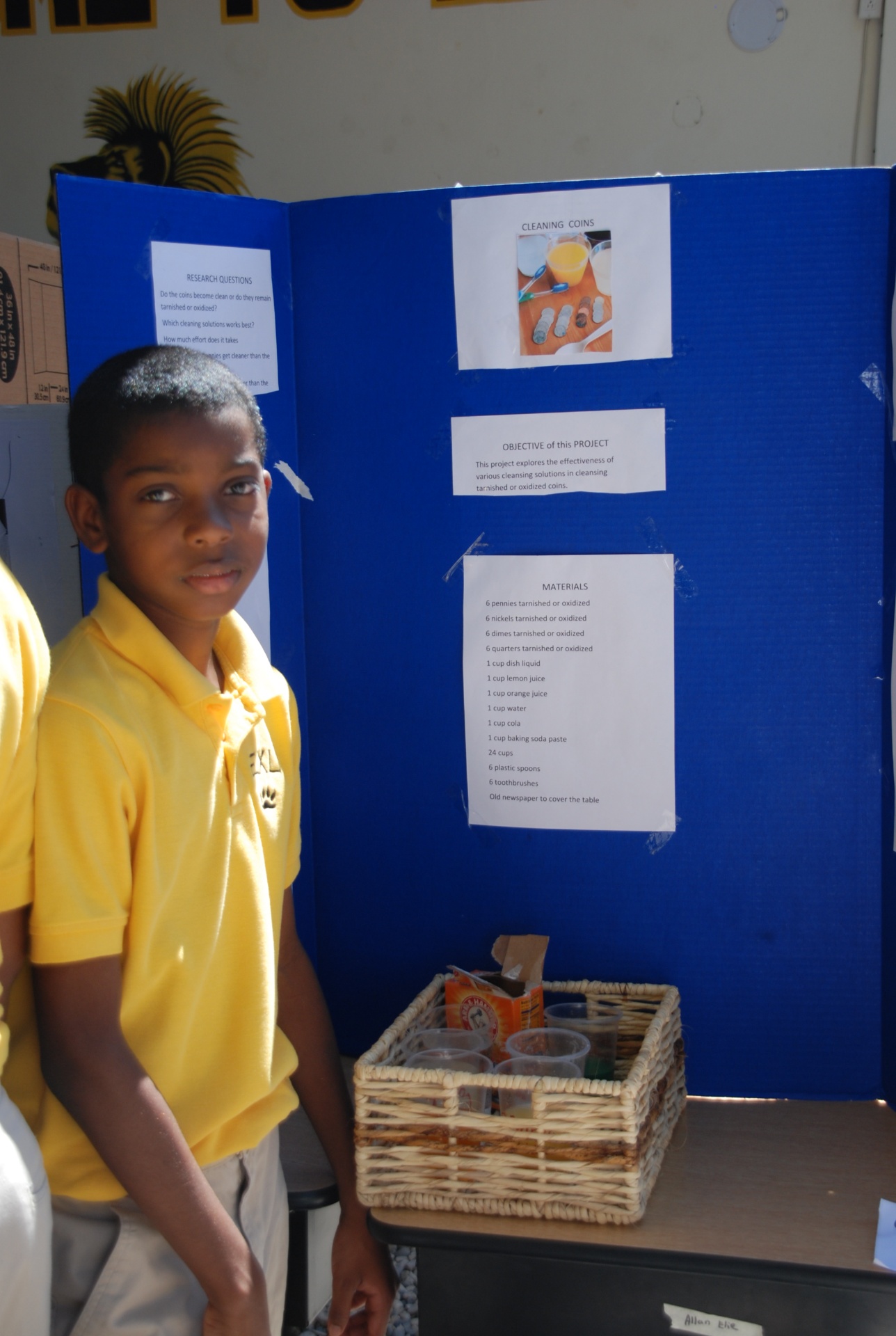 EXL student presenting a science fair project on cleaning coins