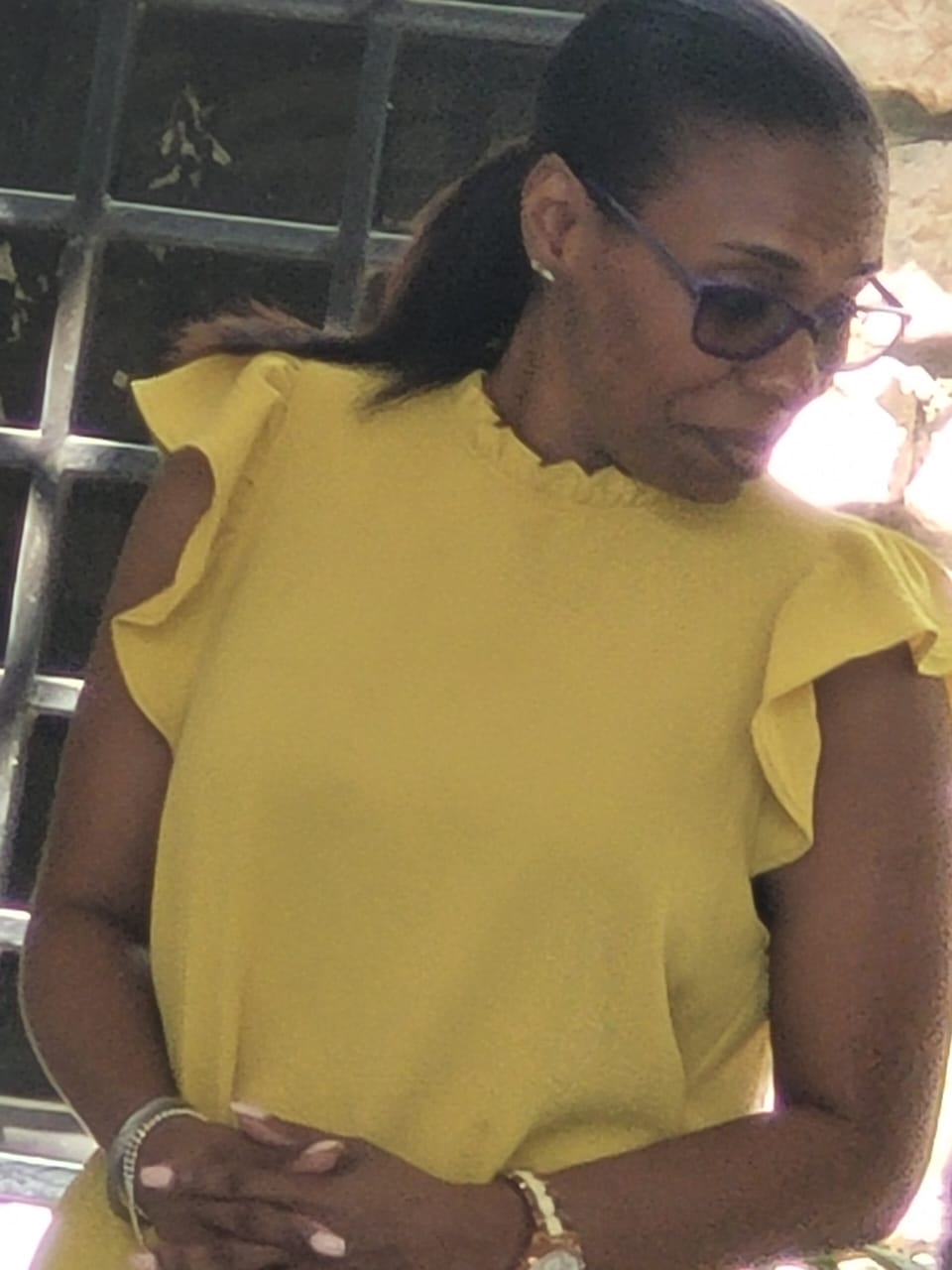 EXL staff member in a yellow ruffle blouse