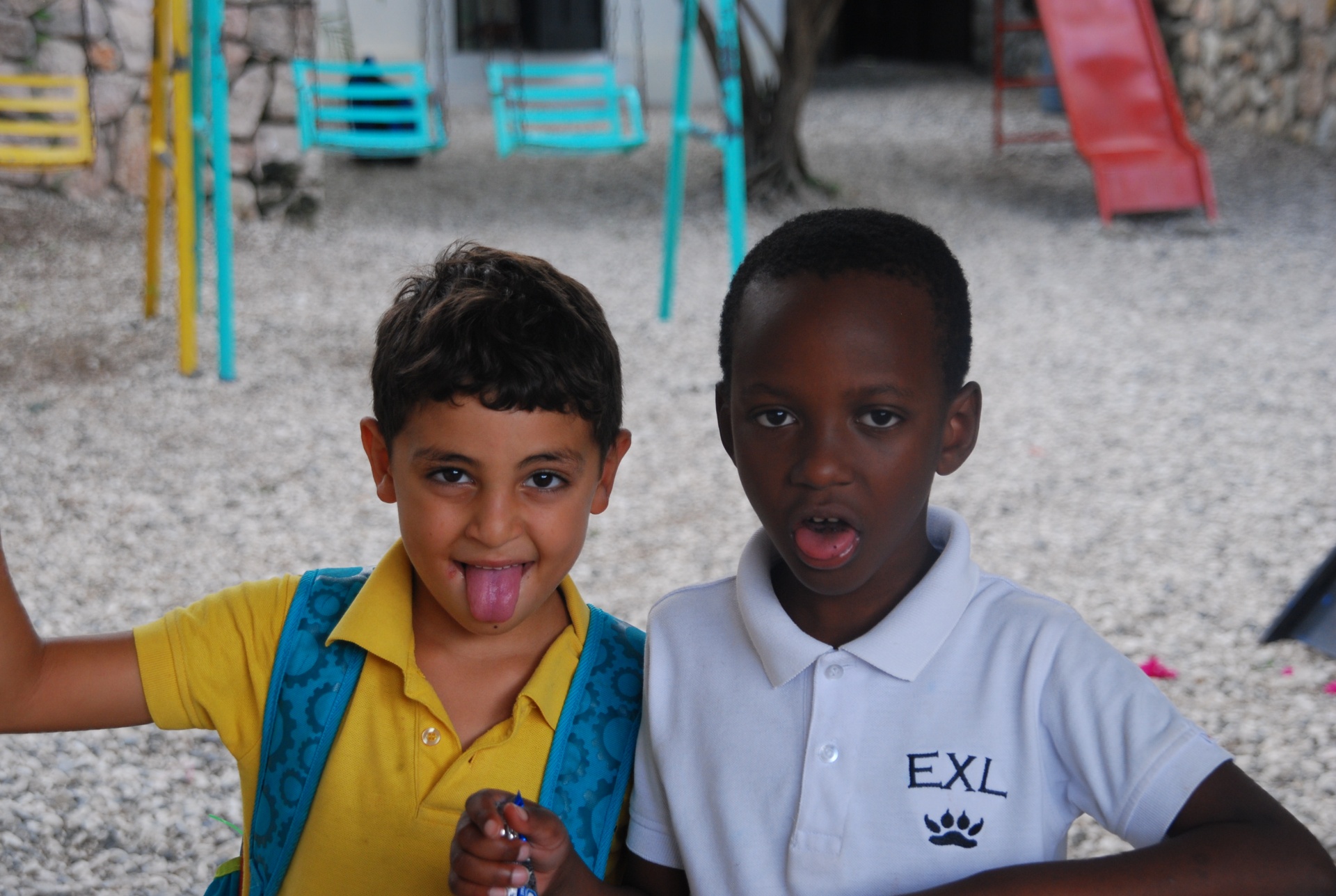 Two EXL students being playful on the playground