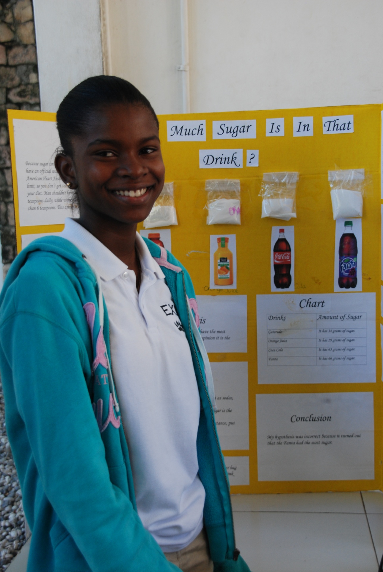 EXL student presenting a science fair project on sugar in drinks