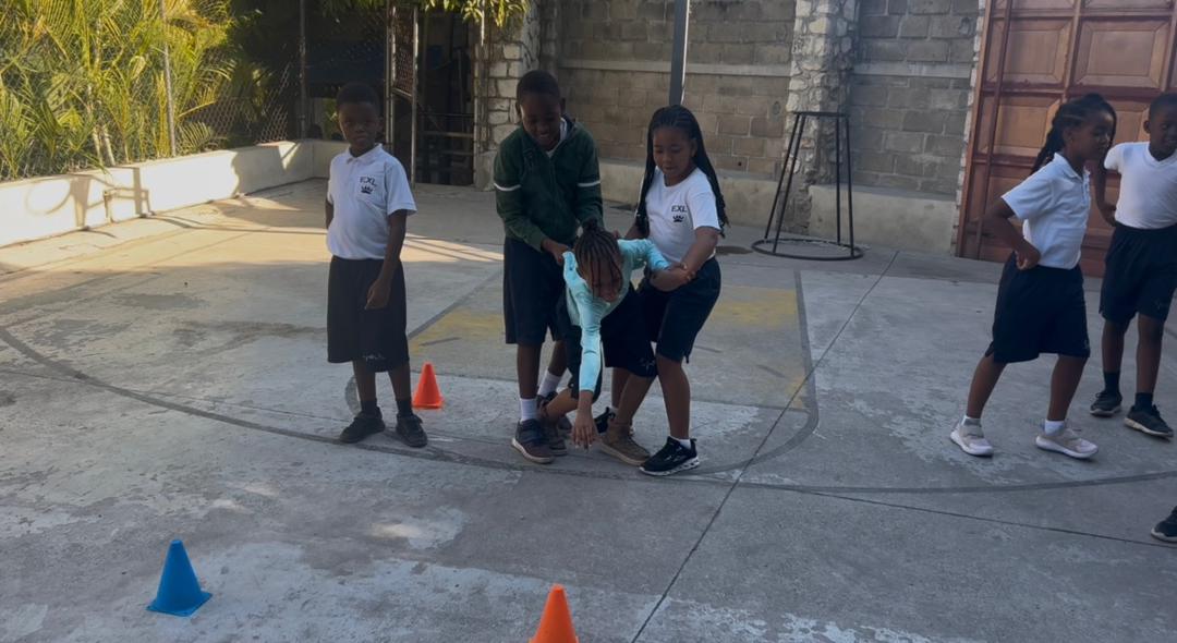 EXL students running cone drills during PE class