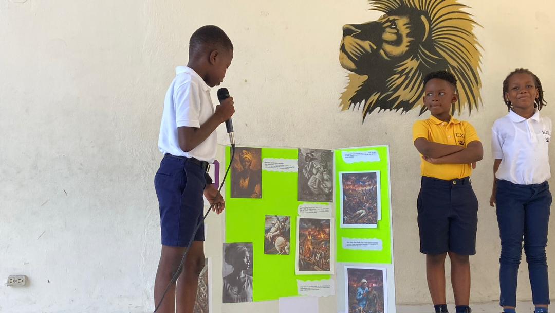 EXL student presenting a history project with classmates listening