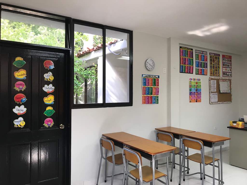 Classroom with student name decorations on door and learning posters