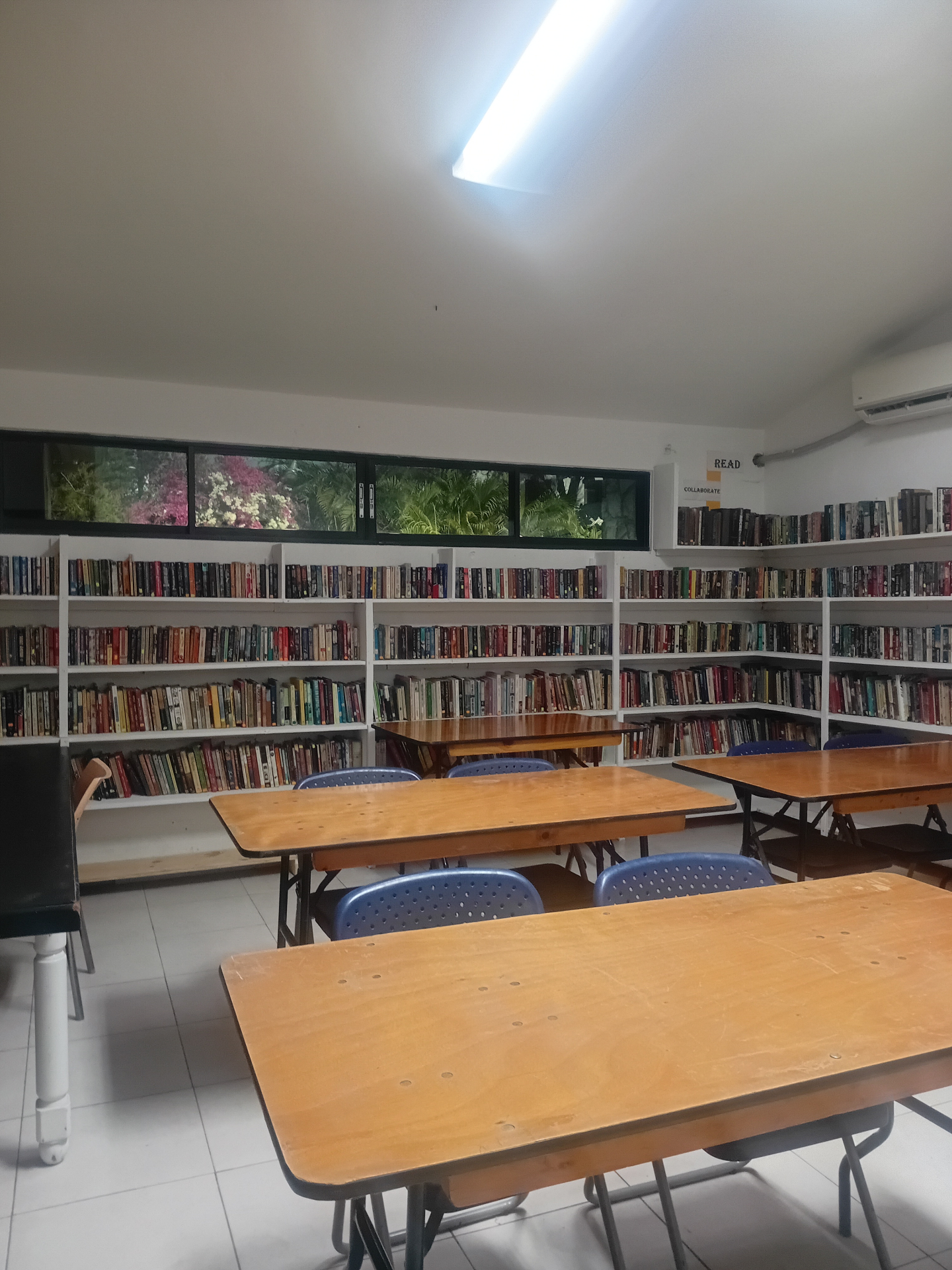 School library with floor-to-ceiling bookshelves and study tables