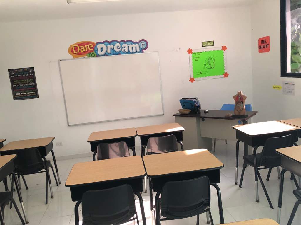 Classroom with whiteboard, anatomy model, and Dare to Dream banner