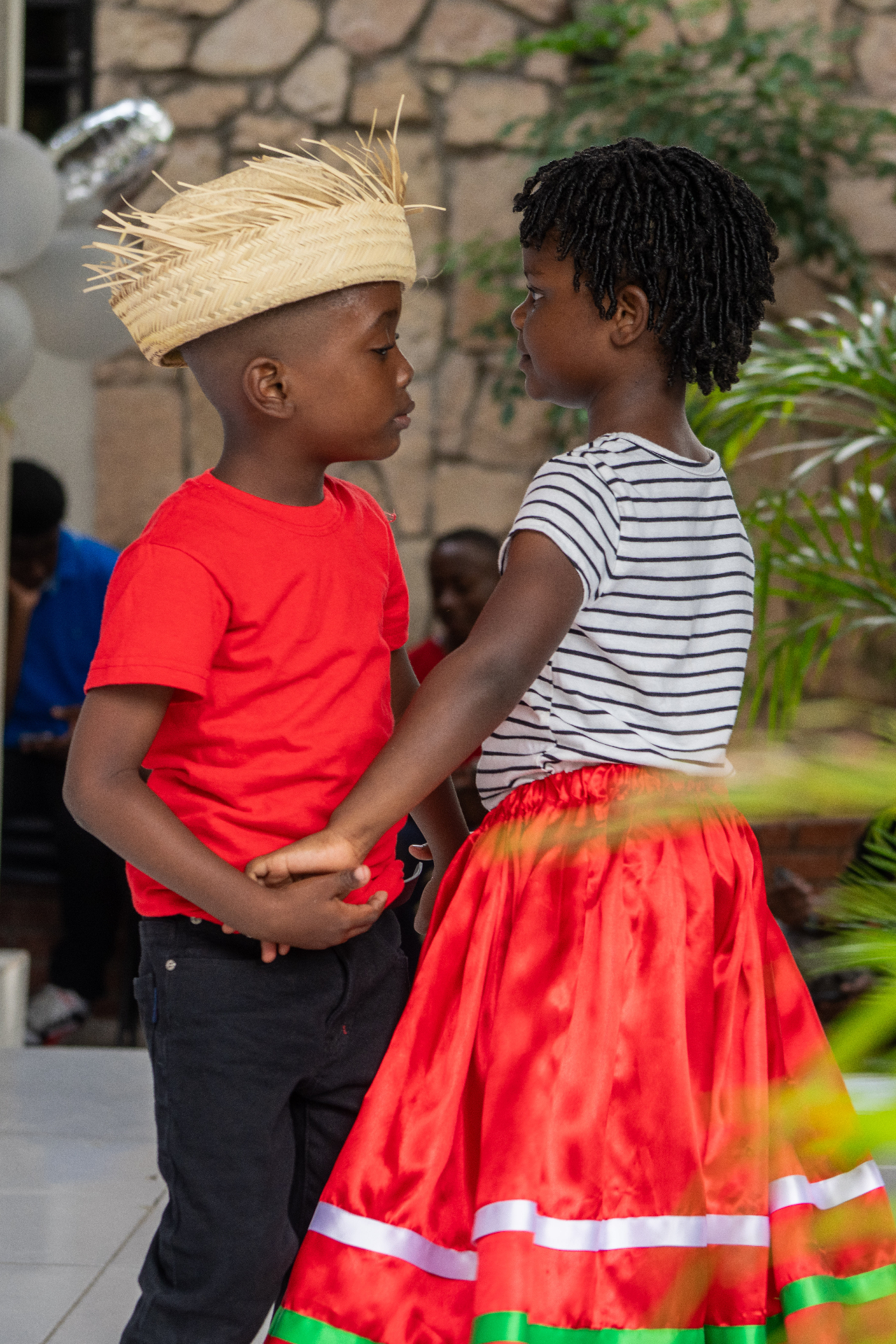 Children in traditional Haitian attire dancing